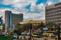 View of Moi Avenue Street with public transport vehicles and people on a busy day in Nairobi, Kenya