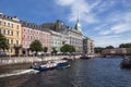 View of the Moika embankment with multi-colored buildings, Red bridge and the Trading house `S. Esders and K. Skheifals` in Sain