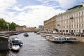 View of the Moika river embankment from the Green bridge, St. Petersburg, Russia. Motor boats for tourists on the Moika river