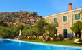 View of Molyvos Village and Castle with hotel pool in foreground. Lesbos Greece. Royalty Free Stock Photo