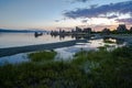 View of Mono Lake in California`s Eastern Sierra Nevada at sunrise with green grass in foreground