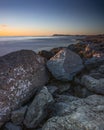 View of Monte San Bartolo and Gabicce from the beach of Riccione at sunrise, in Italy