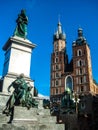 Monument to Adam Mickiewicz and of Towers of the Church of St. Mary on the main Market Square of the Old Town of Krakow, Poland. Royalty Free Stock Photo