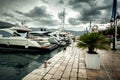 View of moored luxurious yachts at cloudy and rainy day Royalty Free Stock Photo