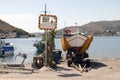 A view of a motorboat, and a motorbike passing by in the reflection of the street mirror against a sea backdrop in the lovely isla