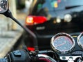 View of motorcycle panel stopped in traffic after rain