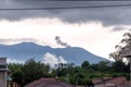 View of Mount Marapi during a small eruption in Bukittinggi, West Sumatra. In the afternoon, with a cloudy sky Royalty Free Stock Photo