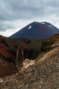 View of Mount Ngauruhoe - Mount Doom from Tongariro Alpine Crossing hike with clouds above and red crater in foreground Royalty Free Stock Photo