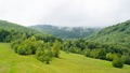 View of Mount Pikuy. way up the mountain through a green meadow and forest. clouds over the mountains. fog over forest Royalty Free Stock Photo