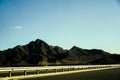 view of mountain hills under clear blue sky from the toll road Royalty Free Stock Photo