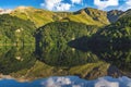View on mountain lake MaralGol in Azerbaijan, green dense forest, reflections Royalty Free Stock Photo