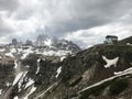 View of the mountain peaks and rocks of the Dolomites in Italy in the Auronzo di Cadore in Tyrol. Hotel building under a overcast