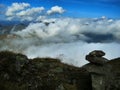 View from mountain range to the valley above fog and clouds Royalty Free Stock Photo