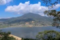 View from mountain ridge to Buyan lake on Bali island in Indonesia. Lush tropical vegetation and tall trees on a steep slope. Royalty Free Stock Photo