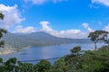 View from mountain ridge to Buyan lake on Bali island in Indonesia. Lush tropical vegetation and tall trees on a steep slope. Royalty Free Stock Photo