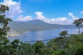 View from mountain ridge to Buyan lake on Bali island in Indonesia. Lush tropical vegetation and tall trees on a steep slope. Royalty Free Stock Photo