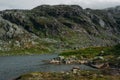 view of mountain river surrounded by hills and stones on shore, Norway, Hardangervidda Royalty Free Stock Photo