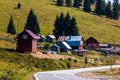 View of mountain road thorugh houses and trees in Bihor, Romania, 2021