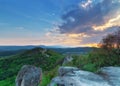 View from the mountain top at sunset with medieval castle ruins in the background on top of hill Royalty Free Stock Photo