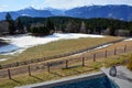 A view of the mountains behind the forest and a winter resort in front of the fence Royalty Free Stock Photo