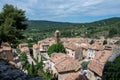 View on mountains cliff, old houses, green valley in remote medieval village Moustiers-Sainte-Marie in Provence, France Royalty Free Stock Photo