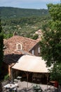 View on mountains cliff, old houses, green valley in remote medieval village Moustiers-Sainte-Marie in Provence, France Royalty Free Stock Photo