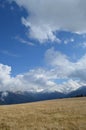 The view of mountains with clouds and deep blue sky