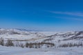 View of the mountains and frozen Lake Baikal on a cloudy day. Olkhon island winter landscape Royalty Free Stock Photo