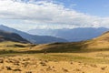 View of the mountains, the meadow, the sky and some cows or horses, in the afternoon. Located in Tambillo Royalty Free Stock Photo