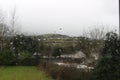 VIEW OF MOUNTAINS OUTSIDE OF DUBLIN IRELAND WITH WATER DROPLETS ON THE GLASS ON A RAINY DAY. TYPICAL IRISH WEATHER