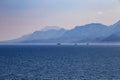 View of mountains and ships in a blue haze off the Mediterranean coast. Antalya, Turkey Royalty Free Stock Photo