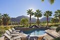 View of mountains from sun loungers near swimming pool in manor house Royalty Free Stock Photo