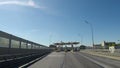 View from the moving car on the modern speedway point of collection of a payment with portly signs and signs with names