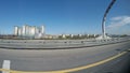 View from the moving car on the modern speedway with portly signs and signs with names of streets in Russian