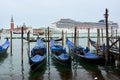 View of MSC cruise ship crossing through San Marco Canal with San Giorgio Maggiore church in the background and gondolas in the fo Royalty Free Stock Photo