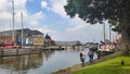 View Of Muiden Town With Sailboat Docked At Port And People Walking On Riverside. Royalty Free Stock Photo