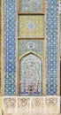 Multicolored geometric ornaments and beautiful Iranian plant motifs on azure tiles on the walls of a mosque in Shiraz, Iran