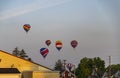 View of Multiple Multi Colored Hot Air Balloons Floating in a Beautiful Morning Blue Sky With Thin Clouds