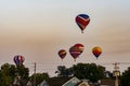 View of Multiple Multi Colored Hot Air Balloons Floating in a Beautiful Morning Blue Sky With Thin Clouds