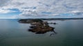 View of the Mumbles headland with the historic lighthouse and piers in Swansea Bay Royalty Free Stock Photo