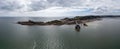 View of the Mumbles headland with the historic lighthouse and piers in Swansea Bay Royalty Free Stock Photo