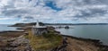 View of the Mumbles headland with the historic lighthouse and piers in Swansea Bay Royalty Free Stock Photo