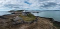 View of the Mumbles headland with the historic lighthouse and piers in Swansea Bay Royalty Free Stock Photo