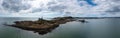 View of the Mumbles headland with the historic lighthouse and piers in Swansea Bay Royalty Free Stock Photo