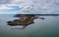 View of the Mumbles headland with the historic lighthouse and piers in Swansea Bay Royalty Free Stock Photo