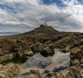 View of the Mumbles Lighthouse in Swansea Bay at low tide Royalty Free Stock Photo