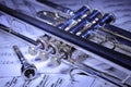 A view of the musical instrument which is the trumpet against the background of the sheet music Royalty Free Stock Photo