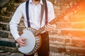 View of musician playing banjo at the street