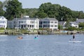 View of Mystic river and village, Connecticut. People on kayaks and pedaling boards. Summer 2021