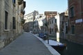 Venice, Italy, October 2021: View of a narrow canal surrounded by old brick houses in Venice. Royalty Free Stock Photo